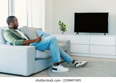 young black man watching tv 260nw 2198497495